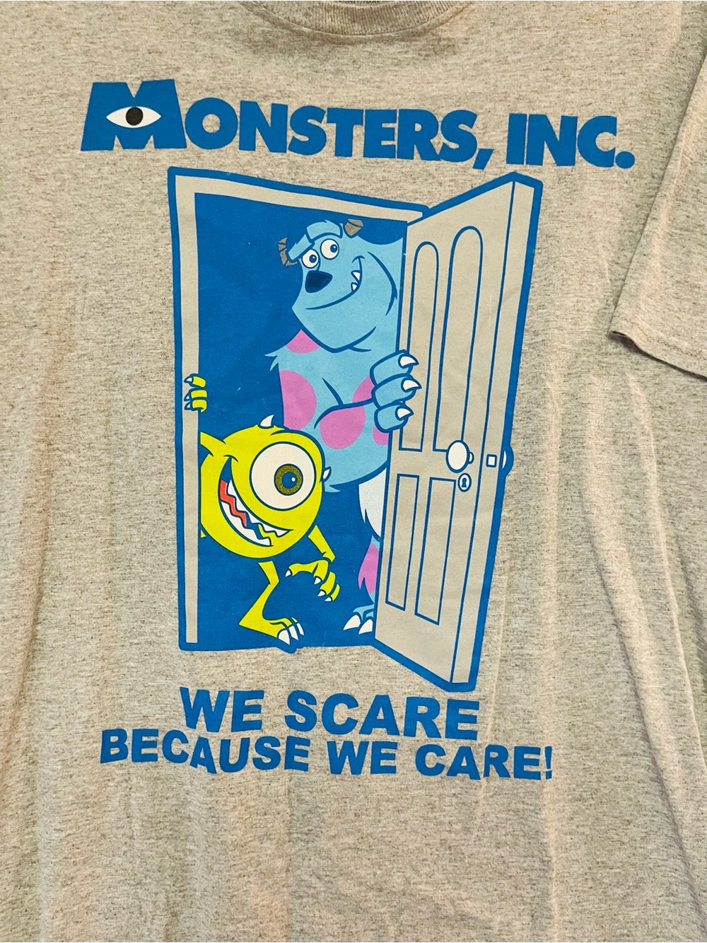 Monsters Inc Pixar Disney We Scare Because We Care Mens Med Gray T Shirt EUC
